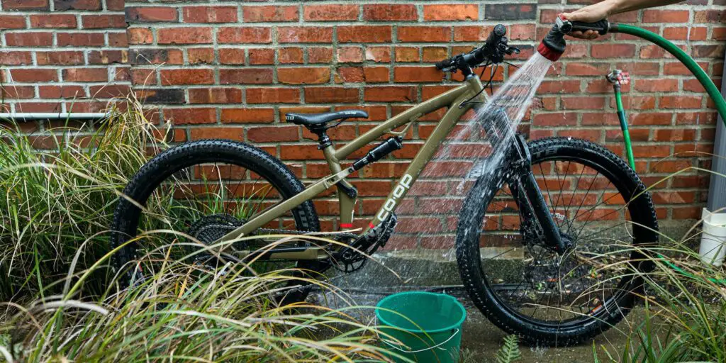 What is the proper way to clean a muddy mountain bike?